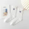 White Japanese JK mid-tube socks with cute purple heart embroidery and elegant ruffle cuffs. - One Size / One Heart on White Background