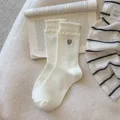 Sweet white ruffled bubble cuff mid-tube socks for women featuring cute grey heart embroidery. - One Size / White Heart