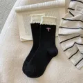 Sweet black mid-tube socks with white ruffled bubble cuffs and cute pink bow embroidery for women. - One Size / Bow Black