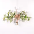Close-up detail of artificial tulip floral swag with burlap bow and bronze bells for wall. - White Tulip