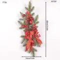 Christmas hanging garland detail showing pine branches, red berries, cones, and bow. - Red