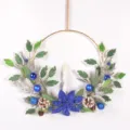 Christmas candle wreath wall hanging with blue poinsettia pine needles pinecones and candles. - Royal Blue with Candle