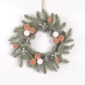 Detailed view of artificial Christmas wreath with pine needles, velvet balls, and pinecones. - Khaki