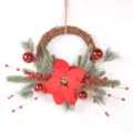 Christmas wreath detail showing poinsettia pine branches and red berries for decor - Poinsettia Pinecone Style