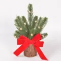 Mini Christmas tree detail with red velvet bow, gold bells and rustic wooden stump base. - Style 86295