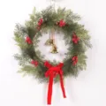 Detailed close-up of Christmas wreath with pine branches, red berries, bells and velvet bow. - Style with Bells