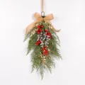 Closeup of artificial Christmas pine teardrop swag with red berries and burlap bow detail. - Red & Silver 87566