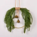 Christmas wreath detail pine needle hanging decor with bells and fairy lights display. - Standard Type