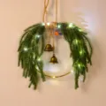Norfolk pine Christmas wreath detail, faux holiday wall hanging with bells and warm LED lights. - With LED Light