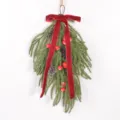 Close-up detail of Christmas teardrop swag featuring a plush velvet bow and pinecones. - Red