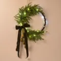 Christmas Norfolk pine wreath with LED lights, wooden beads, velvet bow, and brass bells. - With LED Light / L
