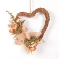 Detailed view of vintage heart-shaped twig wreath with faux roses and burlap bow decor. - Orange 81892