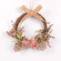 Detailed view of artificial pink rose wreath with rustic burlap bow and eucalyptus foliage. - Pink