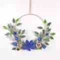 Blue Christmas wreath with golden hoop, pinecones, and blue ornaments for holiday home decor. - Royal Blue