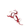 Close-up detail of red velvet ribbon gift box Christmas tree pick and holiday decor. - White