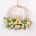 Easter wooden bead wreath detail featuring artificial lamb ear leaves and colorful speckled eggs. - 87118 Knitted Flower+Letter
