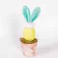 Easter bunny egg potted plant detail, cute plush rabbit ears with moss in terracotta pot. - Yellow