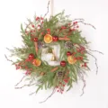 Detailed view of a retro Christmas wreath with faux pine needles, dried oranges, and pinecones. - Bell Style (86115+Bell)