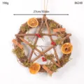 Detailed view of the Christmas rustic pentagram twig wreath decorated with moss and dried oranges. - Pentagram