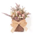 Artificial flower wall hanging in rattan basket with burlap bow for home door decor. - Color 86013