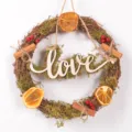 Rustic Christmas vine wreath with dried orange slices, moss, cinnamon and Love wooden sign. - LOVE