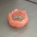 Pink crystal resin lotus bowl detail, epoxy craft decor with gold flakes on wood table. - Watermelon red
