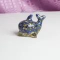 Handmade resin dolphin figurine filled with lapis lazuli chips and gold foil for home decor. - Lapis Lazuli