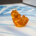 Resin amber turtle figurine detail view, cute transparent orange desk ornament for office decor. - Citrine