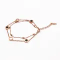 Pulsera doble de acero titanio oro rosa elegante con cuentas redondas y detalle negro blanco. - Rosa oro