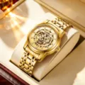 Men's gold automatic mechanical watch with skeleton dial and metal bracelet strap. - Gold Tone