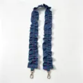Close-up detail view of the blue denim ruffled bag strap featuring red polka dots and gold clasps. - Denim Blue Polka Dots