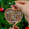 Detailed close-up view of the heart-shaped miniature bookshelf ornament with hanging gold chain. - JH1
