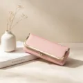 Detail view of pink leather kiss-lock glasses case and storage pouch with metal clasp. - Pink