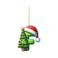Close-up of 2D acrylic Christmas letter F ornament with cute cartoon tree and hat design. - Letter F