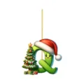 Close-up detail of the Christmas letter Q acrylic pendant with cute cartoon face and tree. - Letter Q