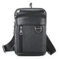 Detailed view of black leather utility bag, showing multi-zipper pockets and D-ring. - Black