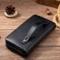 Detailed view of the genuine leather men's long wallet, showing texture and zipper. - Black