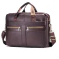 Detailed view of a dark brown leather business briefcase with dual handles and metal zippers. - Coffee