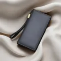 Dark grey genuine leather men's long wallet clutch with wrist strap and zipper closure. - Black