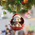 Close-up detail view of the cute cartoon baby dragon acrylic Christmas ornament hanging on tree. - 1