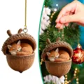 Detailed view of the cute sleeping fox figurine inside a natural acorn shell Christmas ornament. - 8cm / Fox