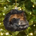 Christmas tree hanging ornament featuring a 2D flat acrylic wolf in a tree cave design. - Tree Hole Wolf