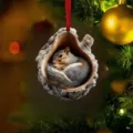 Christmas tree hanging ornament featuring a cute sleeping squirrel inside a realistic tree hollow. - Tree Hole Little Squirrel