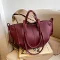 Wine red leather tote bag for women, large capacity shoulder handbag with stylish wing design. - Red
