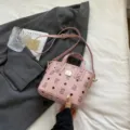 Pink litchi pattern bucket bag with adjustable shoulder strap and top handle design. - No Pendant / Pink