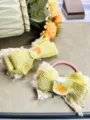 Close-up detail of cute yellow plush bow hair clip and hair tie with crystal cat decor. - Yellow Plush Bow Set (Set 5)
