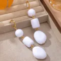 Close-up detail of elegant white and gold long drop earrings featuring chic stacked beads. - French Vintage Long Spiral Geometric White Style (JMX-ER9857)