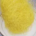 Close-up detail of bright yellow raffia hemp silk gift box packaging filler material. - 100 g / Yellow