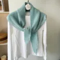 Knitted triangular scarf shawl in soft pastel green, perfect for autumn and winter styling. - Blue