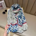 Detailed view of the stylish blue floral and geometric print long fashion scarf fabric. - Blue